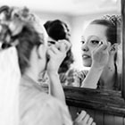 Bride applying make-up
