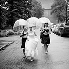 A bride and her bridesmaids walking up the street