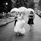 A bride and her bridesmaids walking up the street