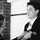 Groom has his boutonniere pinned on