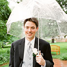 The Groom stands for a portrait in the rain