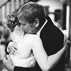 The father of the bride and his daughter share a hug