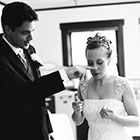 The Groom wipes frosting from the Bride\'s nose