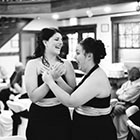 Two bridesmaids share a laugh
