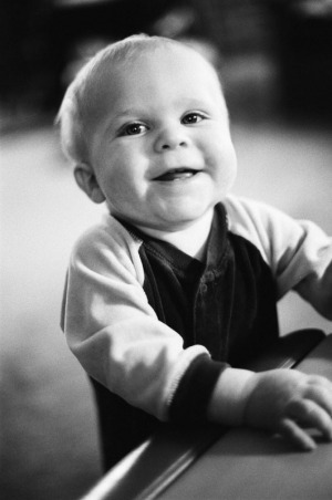 A baby boy smiles for the camera