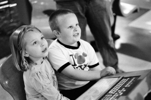 Five year old cousins sit at the scoring table
