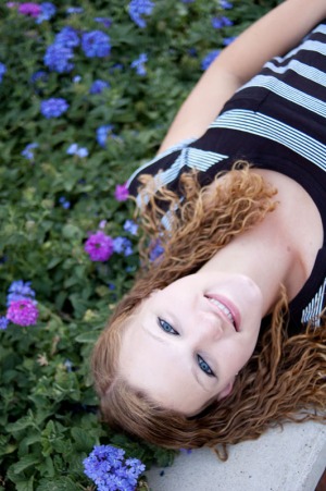 Senior portrait of a young woman lying down.