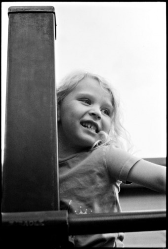 A little girl plays on playground equipment