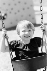 Little girl swinging at the park