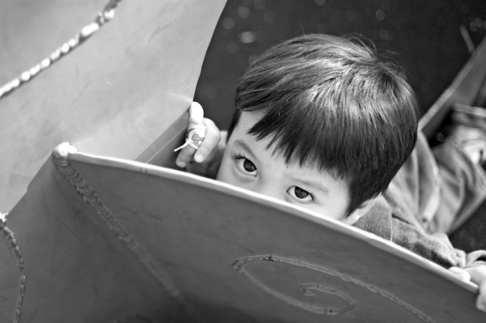 Three year old boy playing on the playground