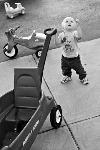A toddler looks up to the sky