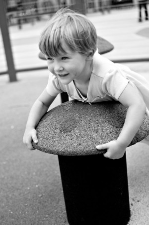 Three year old girl playing on the playground