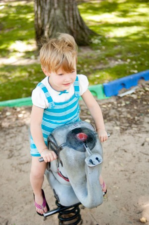 Young girl playing on an elephant