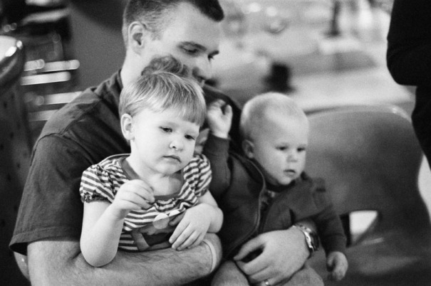 A man holds his son and his niece