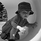 A toddler crawls through a tunnel