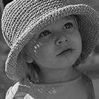Portrait of a young girl in a straw hat