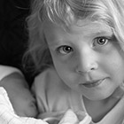 Portrait of a young girl holding her baby sister