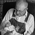  Infant girl being held by her great grandfather