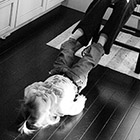 A two year old girl lays on the floor