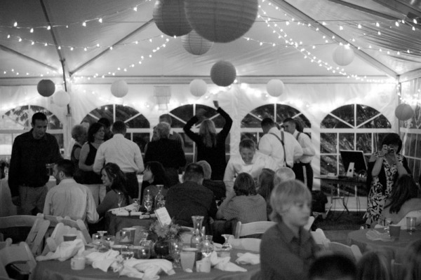Establishing shot of a wedding reception at a home wedding in Louisville, CO. Shot using available light on a Nikon D70s with a Nikon 50mm f/1.8 lens.