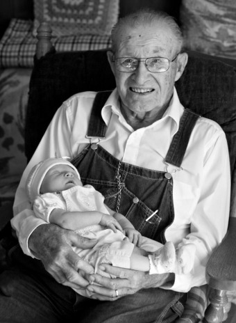 Infant girl being held by her great grandfather