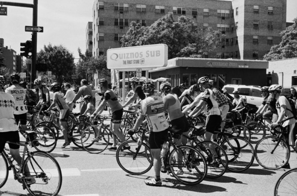A group of cyclists outside of the first Quiznos store