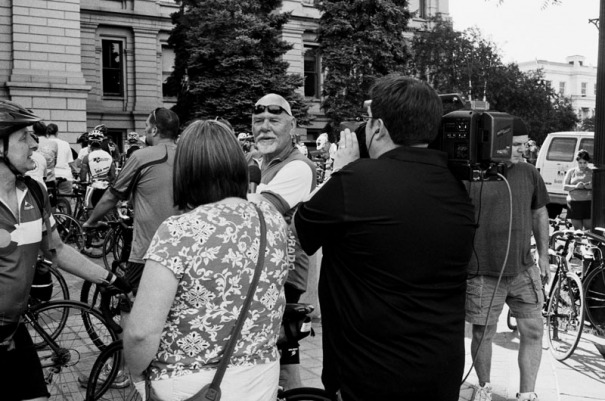 Cyclist is interviewed by a video crew