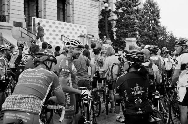 Cyclists talk as they wait for a  press conference