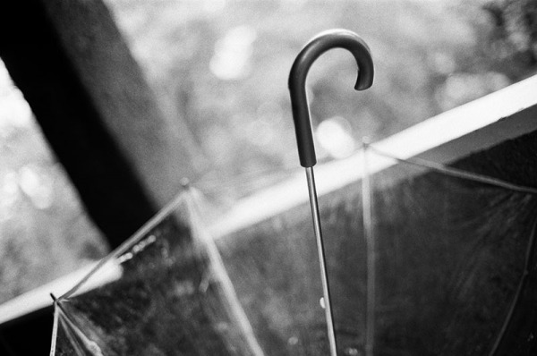 Overturned umbrella on the porch. Black and white detail photograph from a rainy Boulder, CO wedding.