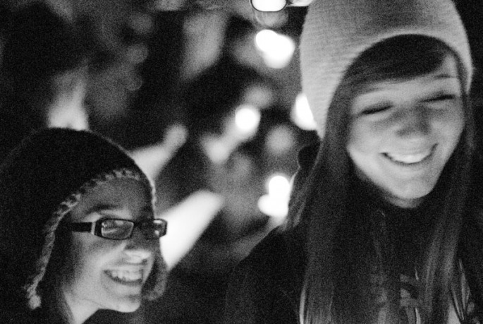 Students laugh as they wait for the celebration to begin