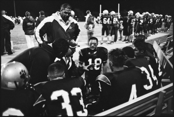 A coach talks to his players