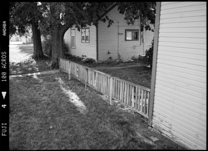 Garage, fence, house and trees