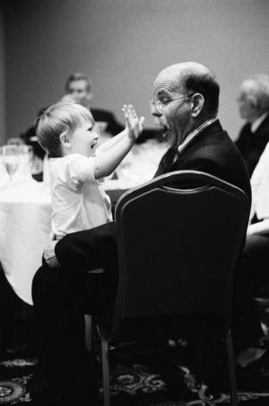 A two year old girl surprises her grandfather at a hotel reception the night before a Bat Mitzvah in Salt Lake City, Utah.