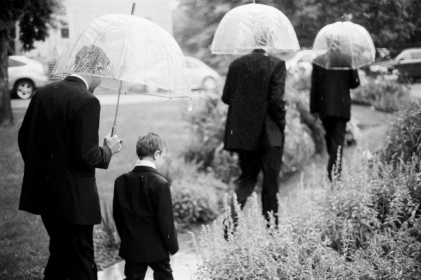 Groomsmen and ring bearer walking in the rain