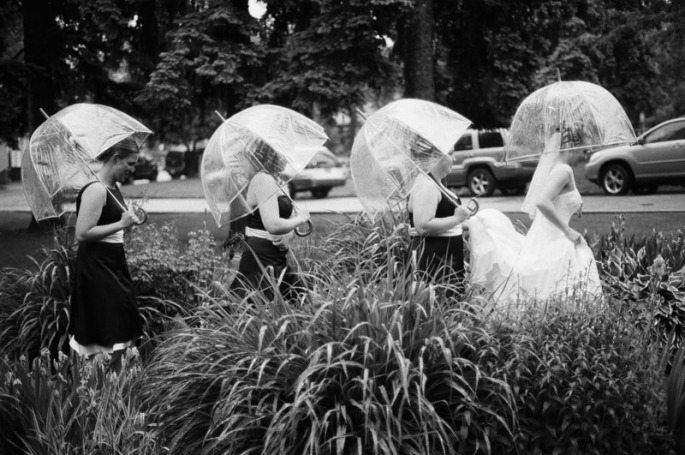 Bride and her bridesmaids walking in the rain