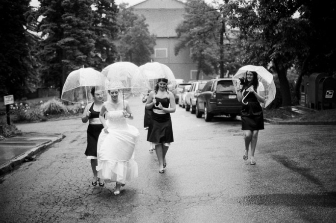 A bride and her bridesmaids walking up the street