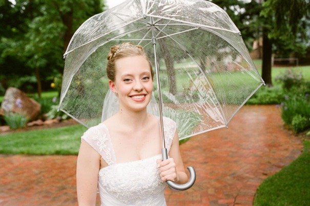 The Bride stands for a portrait in the rain