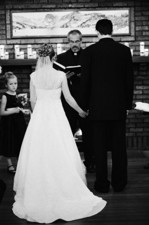 The bride and groom hold hands