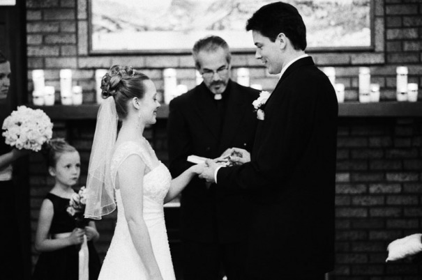 The groom places the wedding ring on the bride's finger