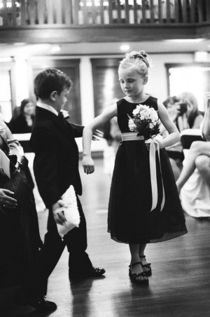 The ring bearer and flower girl meet in the center aisle