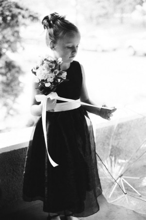 The Flower Girl inspects the ribbon on her bouquet