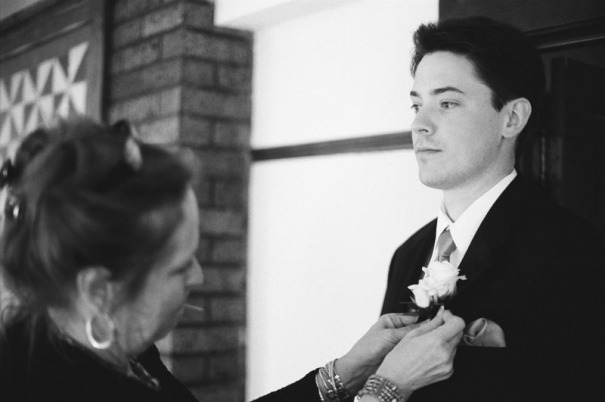 Groom has his boutonniere pinned on