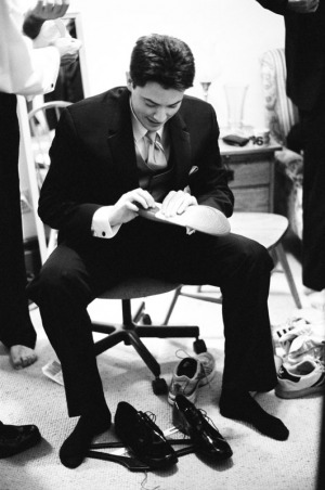 The Groom works on his shoes