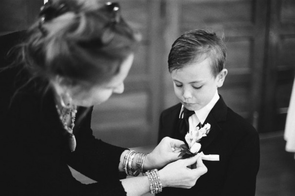 The ring bearer has his boutonniere pinned on