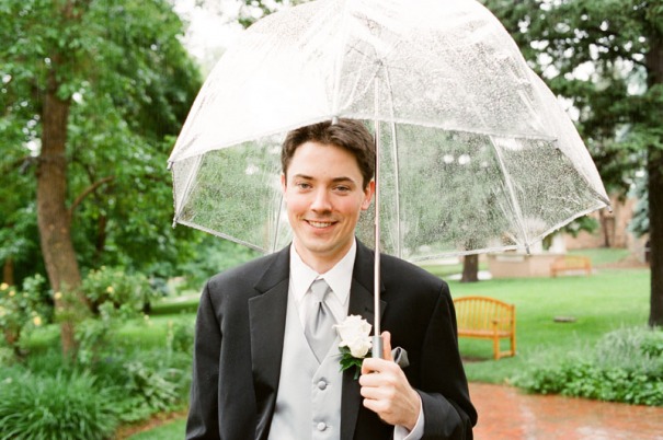 The Groom stands for a portrait in the rain