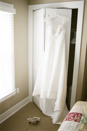 Wedding dress hangs over the closet door