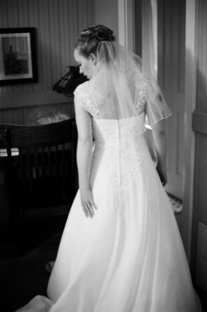 The bride adjusts her dress