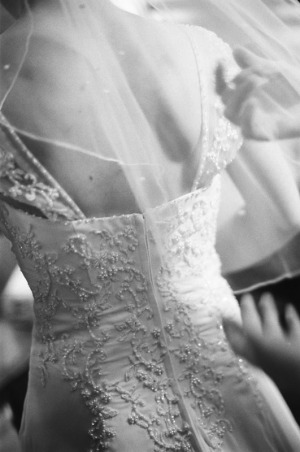 Bridesmaids adjust the bride's veil