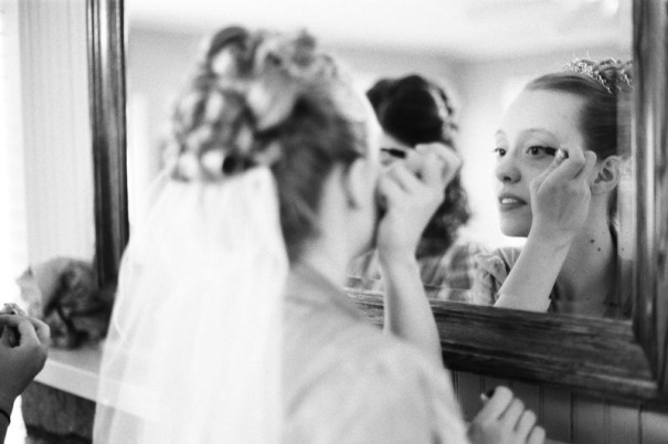 Bride applying make-up
