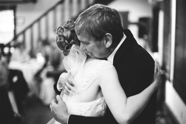 The father of the bride and his daughter share a hug